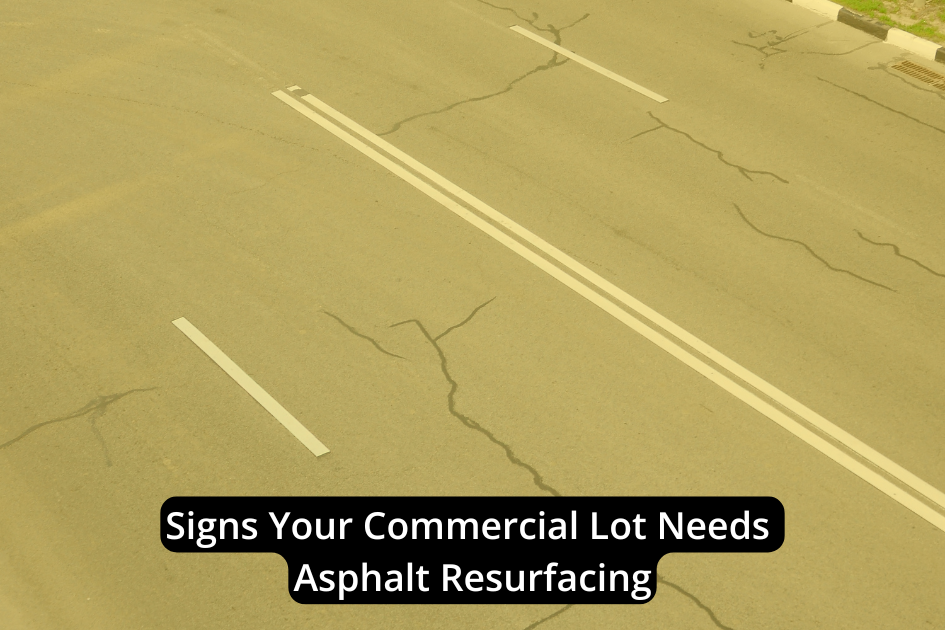 A commercial lot with visible cracks in the pavement and white lane markings; overlaid text reads, "Signs Your Commercial Lot Needs Asphalt Resurfacing." These signs indicate it's time for asphalt resurfacing to maintain safety and curb appeal.